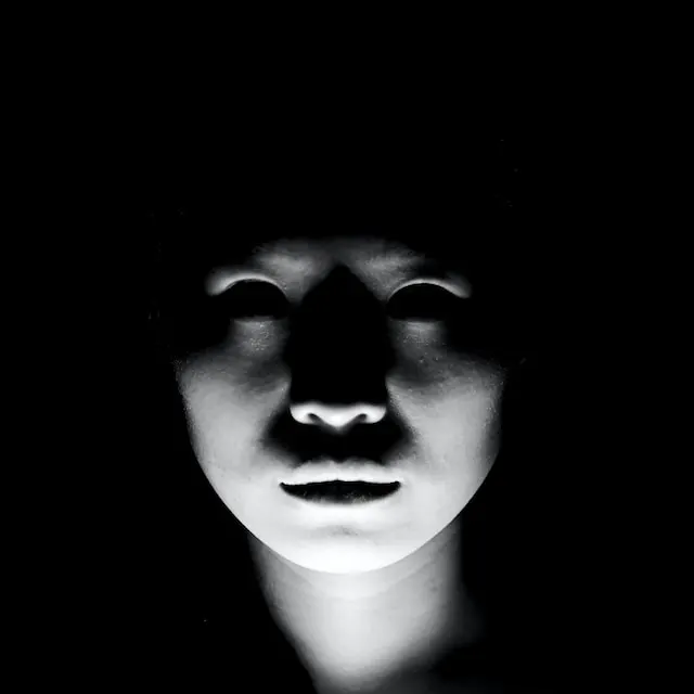 a ghostly white looking face on a black background