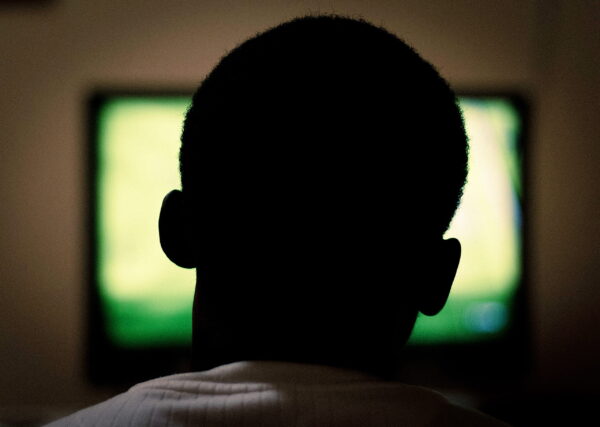 a man sitting in front of the tv