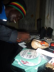 Snapshot of a Black man in a dimly lit room in The Gambia.