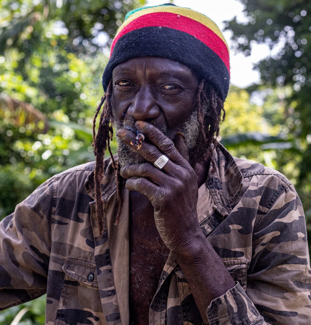 a man in a beanie smoking a joint