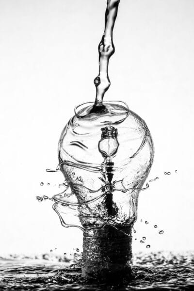 A black and white picture of whirling water in shape of a light bulb