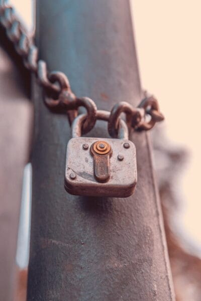 image of a rusty looking steel padlock. 'secret' poem by skendong