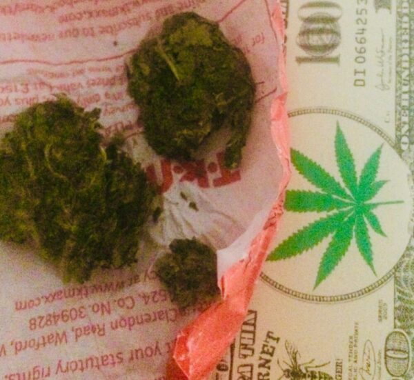 acapulco gold marijuana on a tk maxx receipt beside a $100 US note in Playa Del Carmen - Skendong Poetry