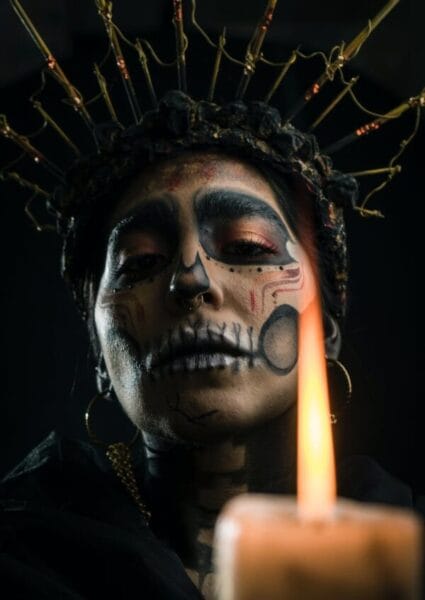 close up shot of woman wearing black and gold headdress