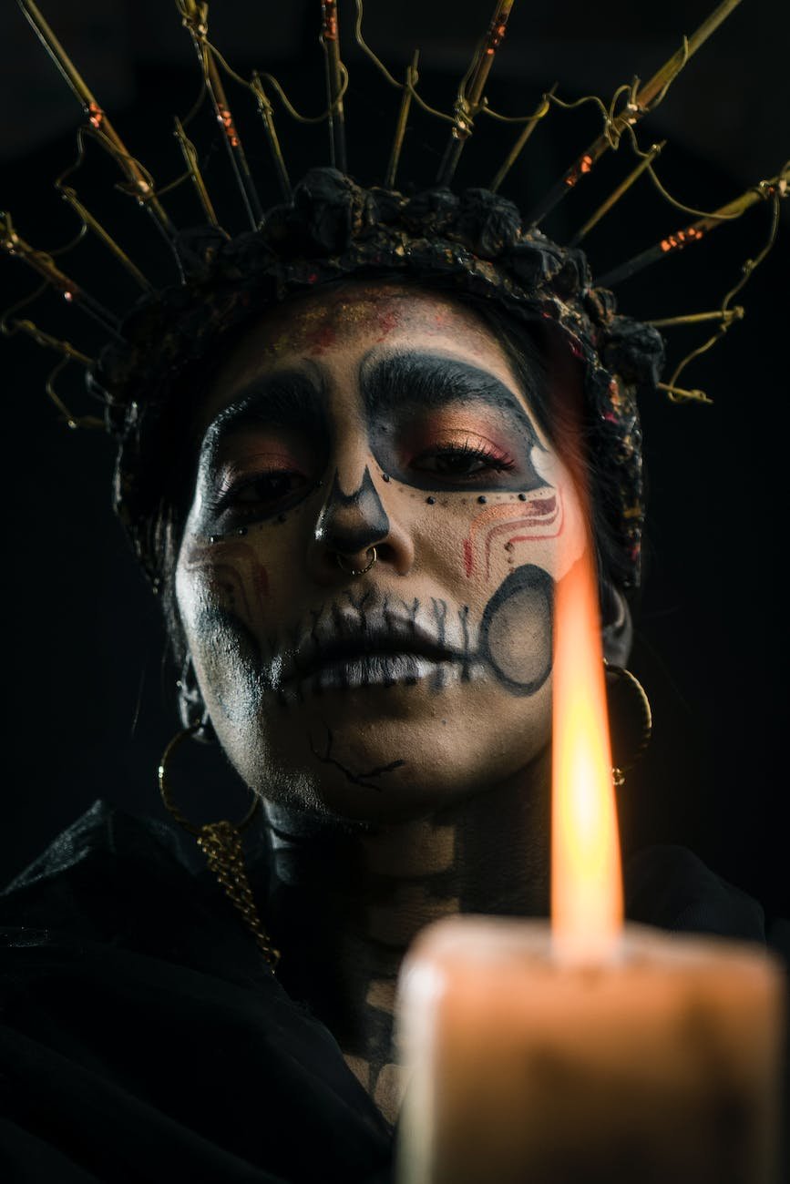 close up shot of woman wearing black and gold headdress