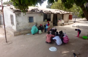 a family eating together in the gambia - skendong