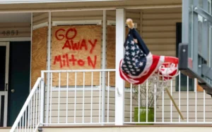 House boarded up in US with "Go Away Milton" on plyboard